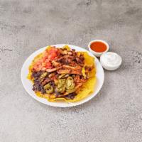 N4. Nachos with Chicken · Homemade white corn tortilla chips covered with melted cheese, salsa ranchera, jalapenos, bl...