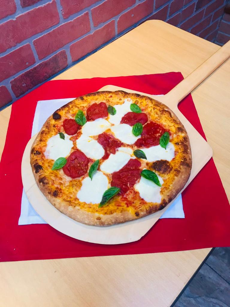 Margherita Pizza · Plum tomatoes, fresh mozzarella, and basil.
