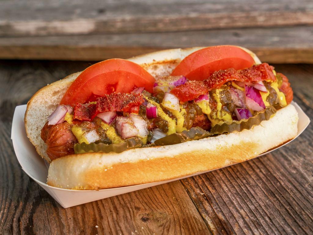 Chicago Dog · Dill pickles, tomato's, sweet relish, yellow mustard, red onion, Mama Lil's peppers, and a dash of celery salt.