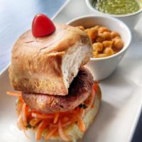Aloo Tikki Burger · Our house made aloo tikki, seasoned with ginger and spices, pan seared crisp. Served on a pa...