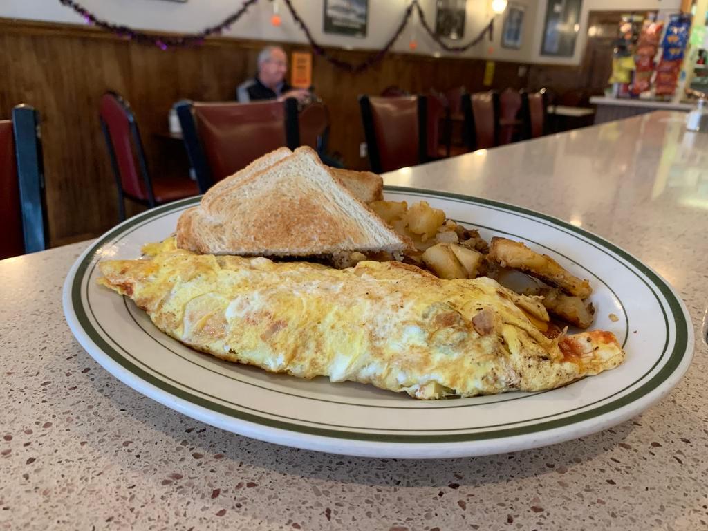 Tex-Mex Omelette · Jalapenos, onions, salsa, cheddar and guacamole. Served with home fries and toast.