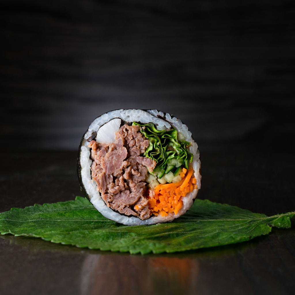 Bulgogi Beef Kimbap · Gluten-free kimbap roll with all-natural beef that has been marinated in a traditional bulgogi sauce and grilled. Includes carrots, cucumbers, pickled radish, red leaf lettuce, perilla leaf, sesame seeds, and sesame oil seasoned rice, all rolled together in a seaweed sheet.
