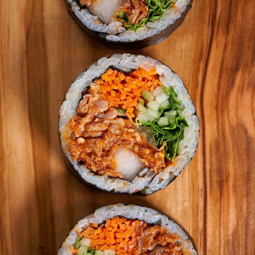 Spicy Pork Kimbap · Gluten-free kimbap roll with all-natural pork that has been marinated in a spicy sauce and grilled. Includes carrots, cucumbers, pickled radish, red leaf lettuce, sesame seeds, and sesame oil seasoned rice, all rolled together in a seaweed sheet.