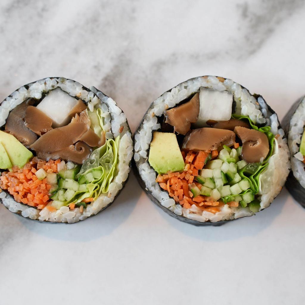 Shiitake Mushroom & Avocado Kimbap (vegan) · Gluten-free kimbap roll with seasoned shiitake mushrooms and avocado.  Includes carrots, cucumbers, pickled radish, red leaf lettuce, sesame seeds, and sesame oil seasoned rice, all rolled together in a seaweed sheet.  