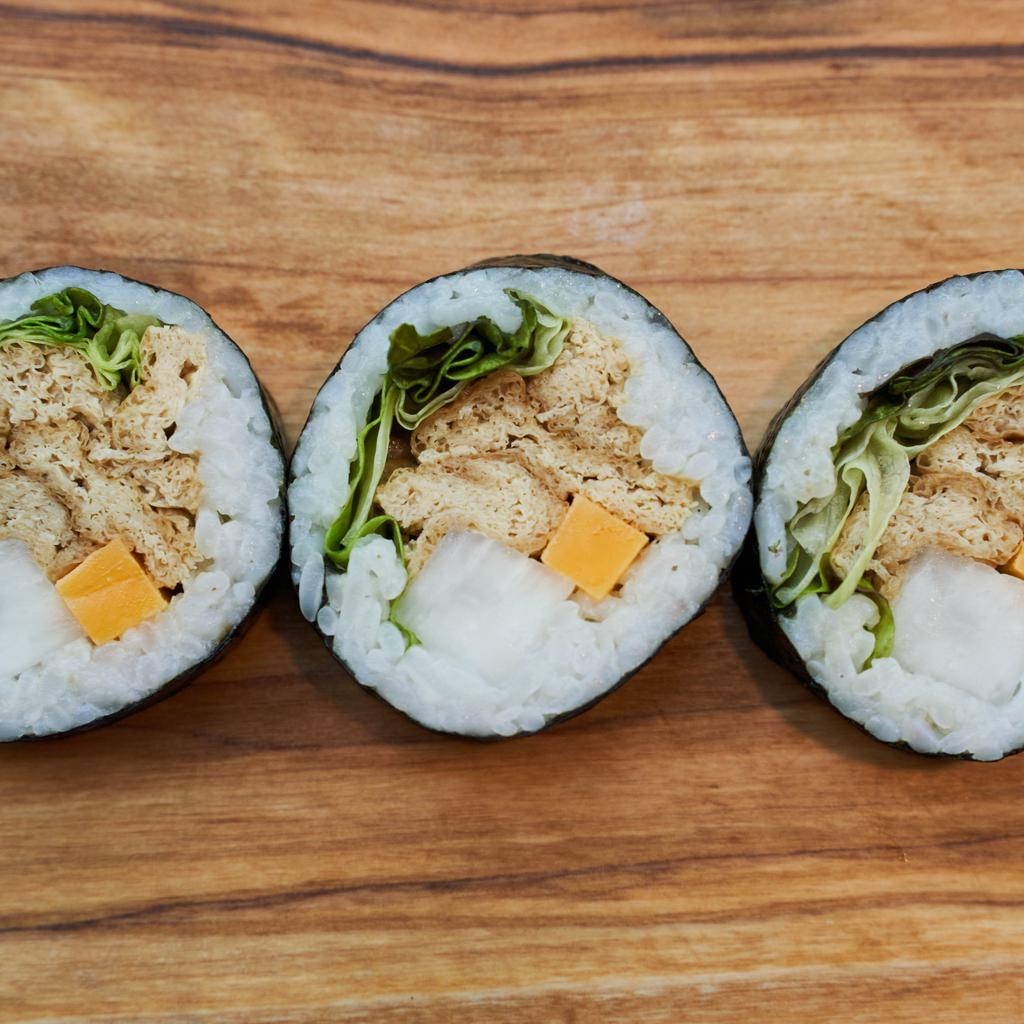 Yubu Kids Kimbap · A small roll with rice, seaweed, cheddar cheese, pickled radish, red leaf lettuce, sesame oil, sesame seeds, and yubu.