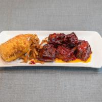 Beef Short Ribs · Succulent beef short ribs served with our house special BBQ sauce.