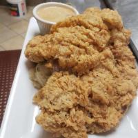 Country Fried Chicken · Deep fried breaded tender juicy chicken breast served with mash and gravy.