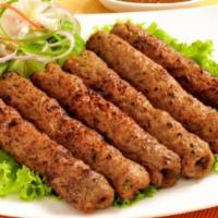 Chicken Seekh Kabab · Spiced minced chicken wrapped around skewers and grilled until well done.