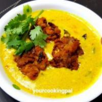 Kadhi Pakoora · Mixed vegetable pakora in yogurt curry.