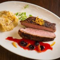 FIVE-SPICE DUCK STEAK · crispy skin, sour cherry jus & smoked cheddar grits
