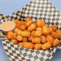 Cajun Tots · Crispy tots tossed in bold cajun spices. Paired with chipotle tomato aioli.