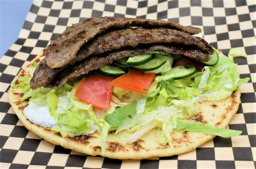 Gyro Wrap · Seasoned beef slices, shredded lettuce, tomatoes, cucumbers, onions, tzatziki sauce. Wrapped in toasted naan. 