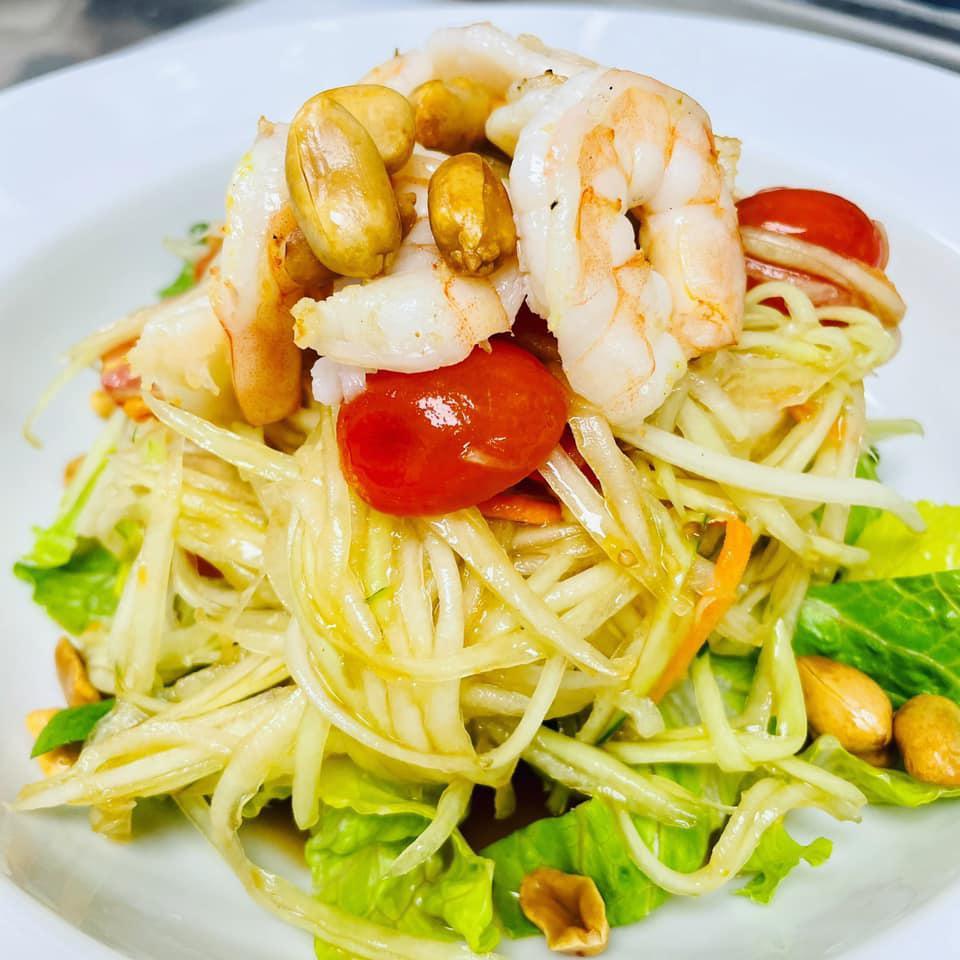 Som Tum · Papaya salad. Shredded papaya, carrot, green beans, tomatoes, peanuts, and chili, topped with grilled prawns.