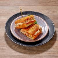 Turkey Panini · Roasted turkey breast, melted Brie, tomato and house made pepper jam.