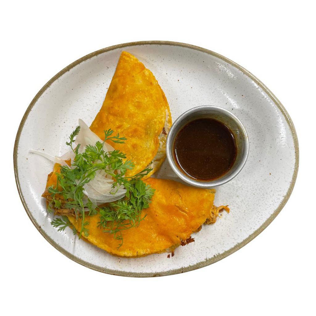 Quesabirrias · The iconic traditional dish from jalisco with a chicken) personality, is served in 2 handmade tortillas with birria broth on the side, to deep-in your quesadillas.