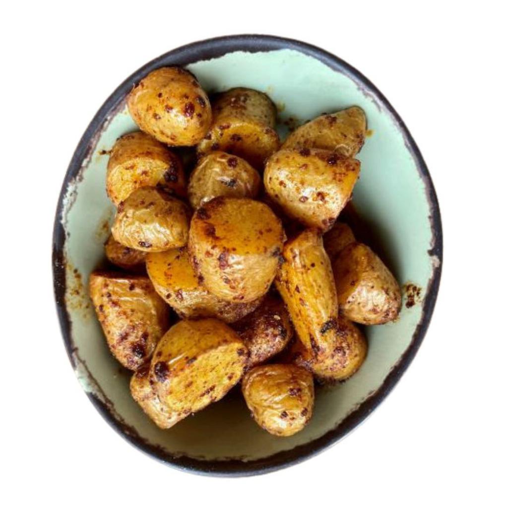 Papas Machas · Yukon baby potatoes tossed with spicy salsa macha.