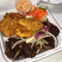 Goat Platter · Marinated and fried to perfection. 
Served with red beans and rice, salad, and plantains.