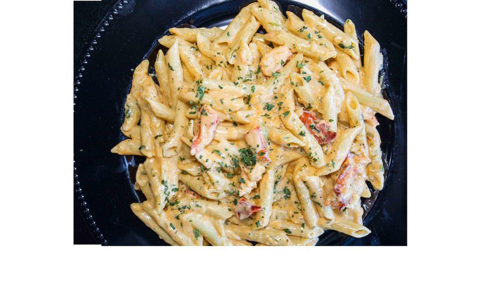 Lobster Pasta · Maine lobster claw chunks tossed in a creamy Alfredo style pasta.