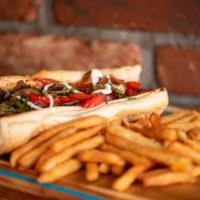 Philly Cheese Steak Sandwich · Grilled flank steak sandwich served with cheddar cheese and grilled onion.