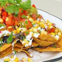 Westwood Nachos · Pico de gallo, guacamole, refried beans, cheese sauce, corn, cilantro, crema Fresca.