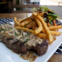 Steak Frites · 10 oz. Hanger Steak, Creamy brandy peppercorn sauce. Served with fries and a salad.