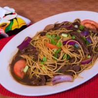 Tallarin Saltado · Peruvian sauteed pasta with sliced chicken or beef, tomatoes and onions in soy sauce. 