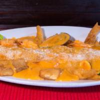 Pescado a la Macho · Seasoned fish with seafood in spicy Peruvian sauce with rice