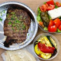 Rib Eye Steak · Served with one hot side order and greek salad, and pita bread. 