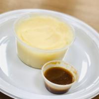 Mashed Potatoes · Prepared from fresh potatoes and served with gravy on the side. 