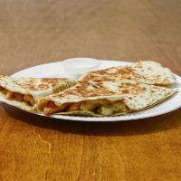Quesadilla  · Fresh chicken made with green peppers onions and fresh cheese. Taste of heaven and a bite 
