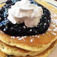 Blueberry Pancakes Breakfast · 4 original buttermilk pancakes, filled with blueberries and topped with blueberry compote.