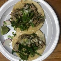 Carnitas Taco · Fried pork. Served with onions, cilantro, onions, radish, limes and salsa on the side.