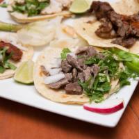 Lengua Taco · Beef tongue. Served with onions, cilantro, onions, radish, limes and salsa on the side.
