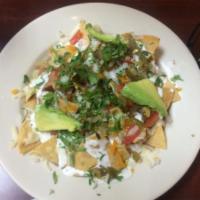 Nachos Regulares · Nachos with beans, cheese, sour cream, tomato, jalapenos, onions, cilantro and avocado.