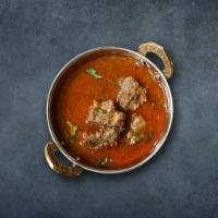 Capital Lamb Curry · Lamb pieces marinated and cooked in thick gravy with tomato, onion, spices.