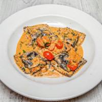 Black Squid  Seafood Ravioli · Scallops, lobster and shrimp with fresh tomatoes and cream parsley sauce.