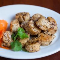 Black Pepper Scallops · Scallops are quickly seared and coated with soy sauce and black pepper. A Hong Kong specialty.