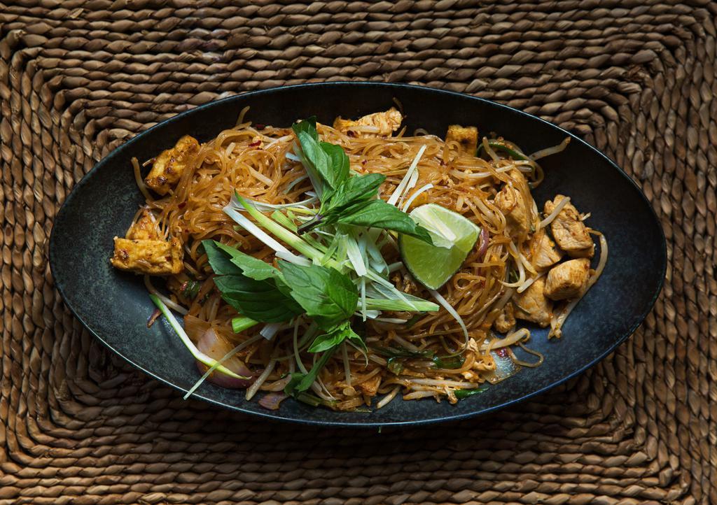 Chicken Pad Thai · A classic Thai noodle dish with chicken, fried tofu, egg, peanuts, chives, and thin rice noodles.