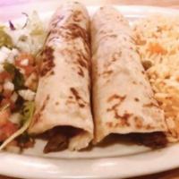 Tacos al Carbon · Two tacos with strips of light marinated charbroiled beef skirts, wrapped in flour tortillas...