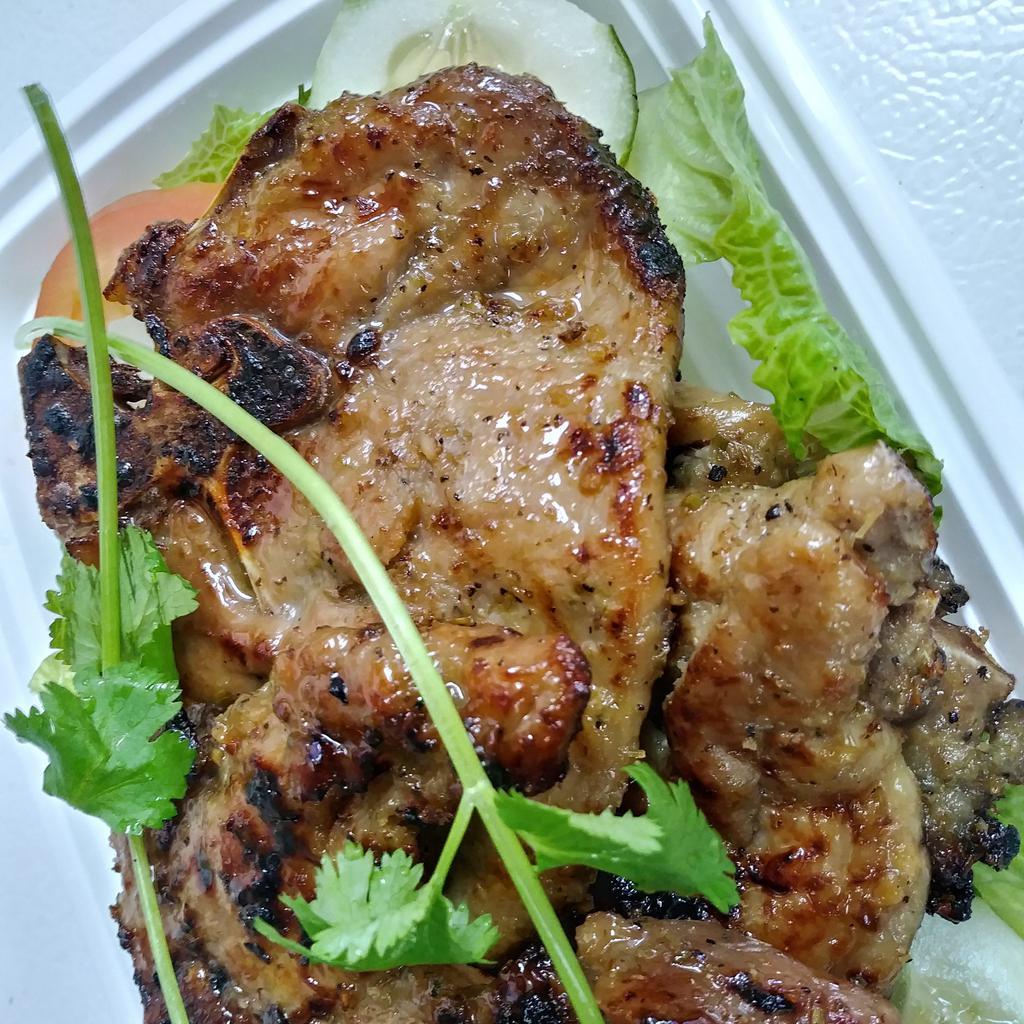 12. Vietnamese Pork Chop · Grilled marinated pork chop with lemongrass and sauce on the side.