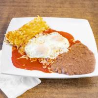 Enchiladas Montadas Breakfast · Enchiladas topped with 2 eggs served with hash-browns and beans.