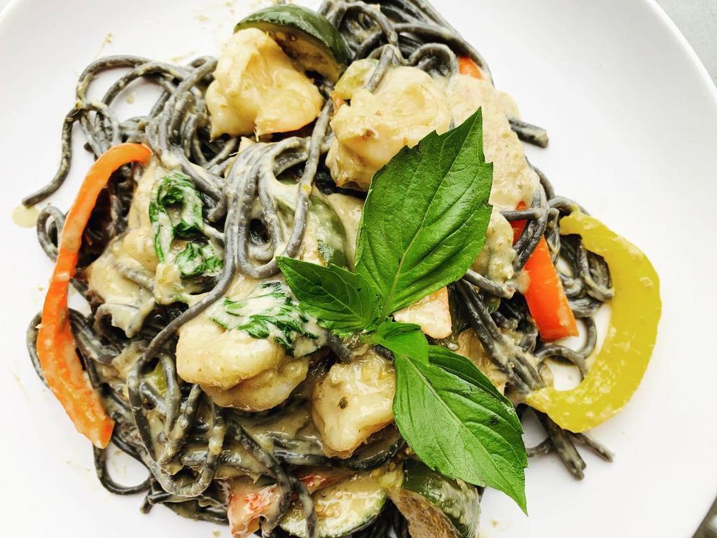 Squid ink Pasta Creamy Green Curry · Green curry paste, coconut milk, limes leaves, Thai eggplant, green beans, basil, various bell pepper. All curry and stir fried with squid ink pasta