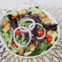Garden Salad · Freshly picked spring mix, cherry tomatoes, cucumbers, sliced red onions, croutons.