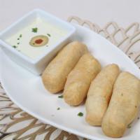 Tequenos (5pcs) · Cheese stick wrapped with wheat flour dough served with special sauce guasacaca.