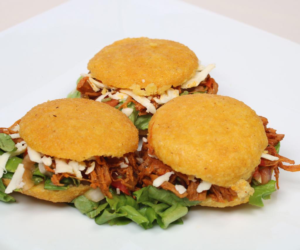 Arepitas · 3 pieces. Delicious mini fried arepas filled with shredded beef or chicken, and cheese.