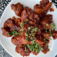 Gobi Manchurian · Cauliflower marinated in corn flour batter spices, deep-fried and tossed in traditional chil...
