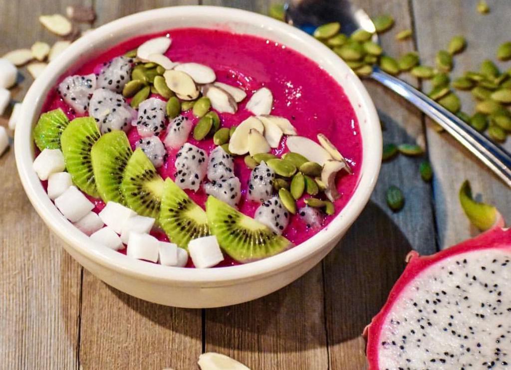 Pitaya Smoothie Bowl · Dragon fruit, mangoes, strawberries, kiwis, coconut cubes, pumpkin seeds and granola. Benefits: high fiber, promotes healthy cut, improve heart health.