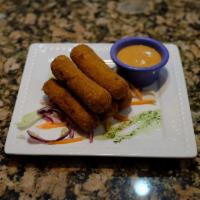 Croquetas de Pollo · Breadcrumbed and Fried. Ground chicken mixed with herbs and spices rolled with breadcrumbs t...