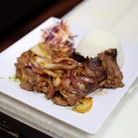Bistec Encebollado · Seared thin cut steak with caramelized onions. Served with your choice of side.