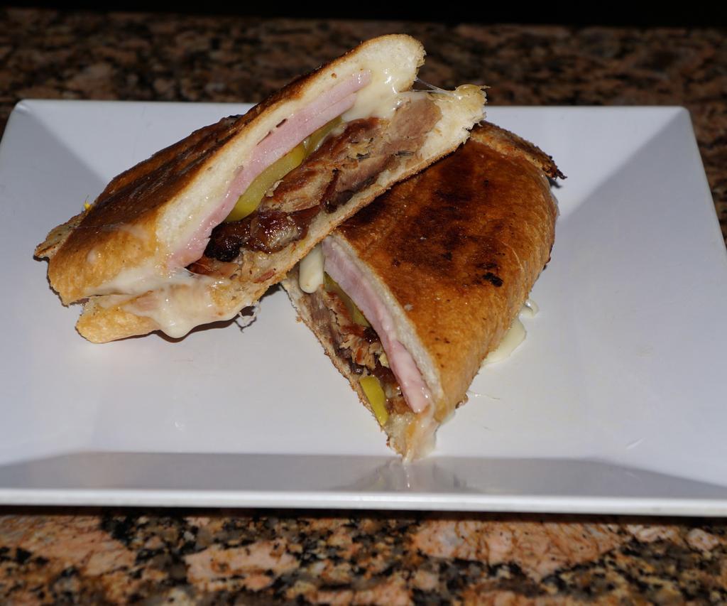 Cubano Sandwich  · Delicious roast pork, ham, and Swiss cheese. Taste great with pickles but thats up to you!Please select from the drop down menu the condiments you would like in your sandwich.
